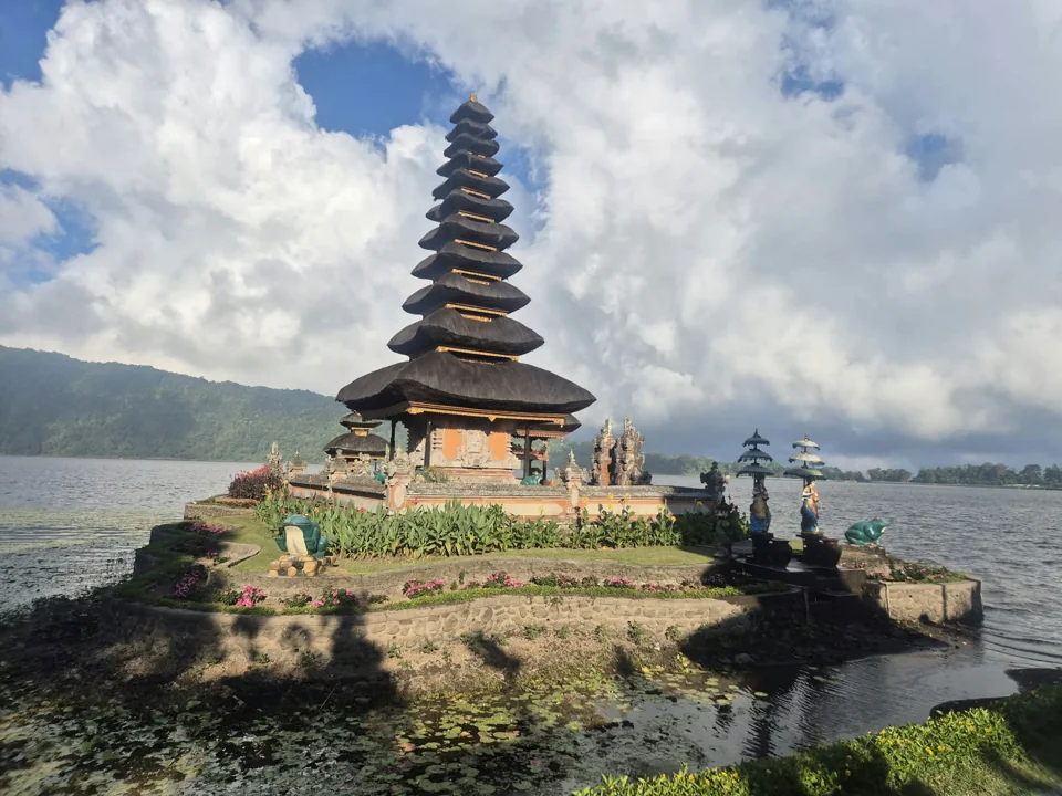 A temple beside a lake, with mountains in the background